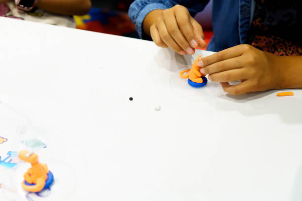 istock A child is playing with a toy that has a blue and orange color 2149767974