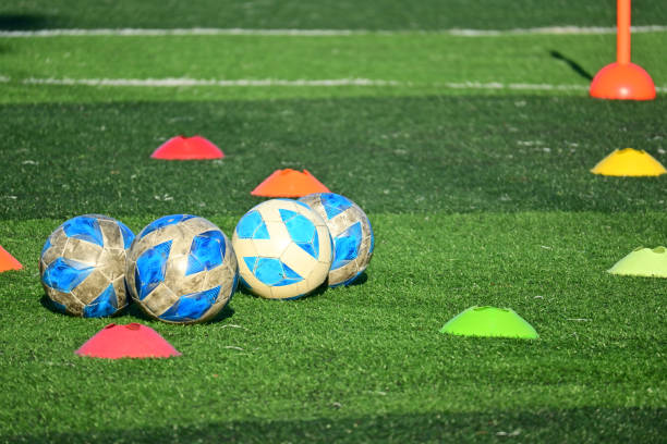 istock artificial green grass soccer field with training cone and ball 2149768423