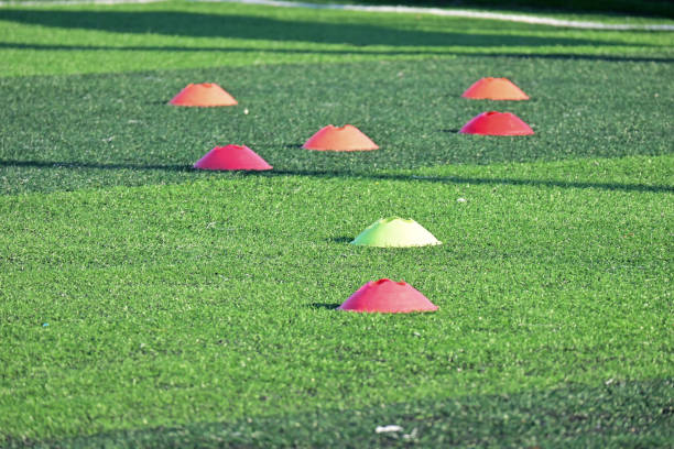 istock artificial green grass soccer field with training cones 2149768424