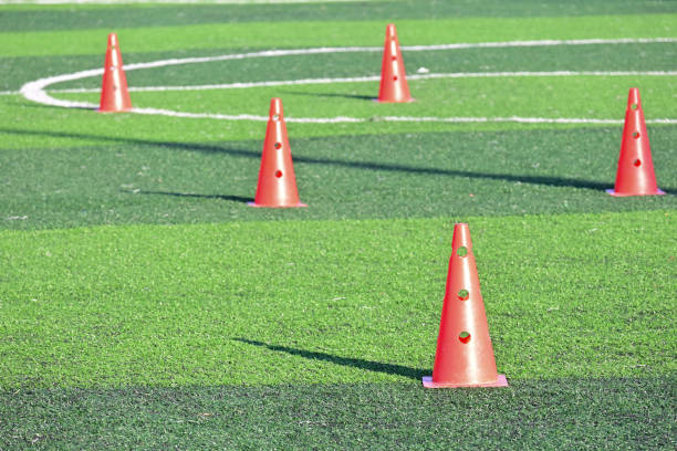 istock artificial green grass soccer field with orange training cones 2149768426