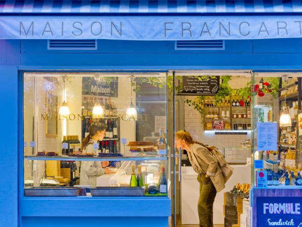 The City of Paris France on October 19, 2023:   Patron making selections at a Paris sandwich shop and patisserie in the Latin Quarter, France