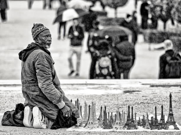 Sydney, Australia - January 07, 2024: Homeless old woman sitting in Pitt street with her two dogs, black and white