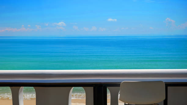 istock blank seaside working space terrace with white bar stool and balcony and blurred blue sea in background 2149770506