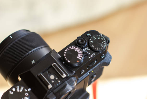 istock The black retro designed camera is mounted on a tripod for making photo or video footage. Wheels on the camera for setting up. 2149770556
