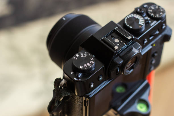 istock The black retro designed camera is mounted on a tripod for making photo or video footage. Wheels on the camera for setting up. 2149770865