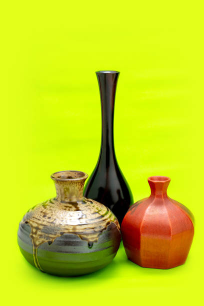Three white vases on black background with copy space