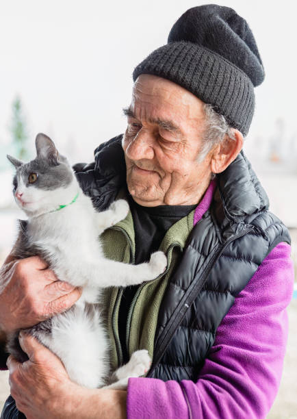 istock Old Russian man holding his cat and smiling 2149771247
