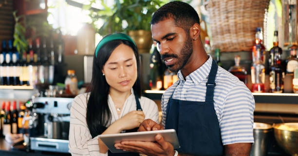 istock Tablet, restaurant bartender and team discussion on alcohol stock, store trade or bar inventory in startup business. Planning, hospitality service and entrepreneur cooperation on drinks supply chain 2149772396