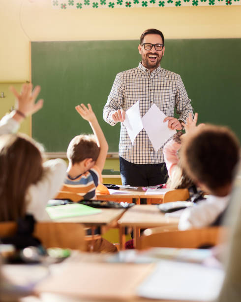 istock Happy male teacher giving a lecture at elementary school. 2149774192
