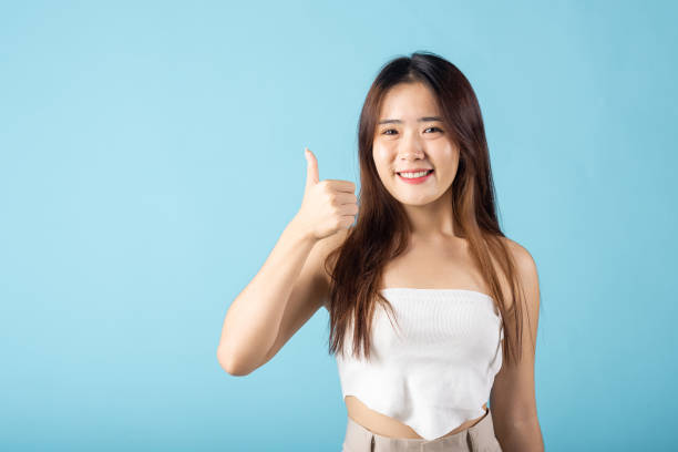 istock Asian young woman showing thumb up 2149774597