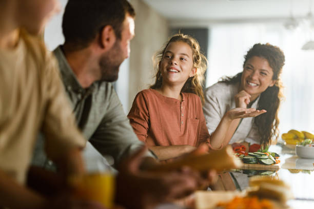 istock Happy family talking while preparing a meal in the kitchen. 2149774756
