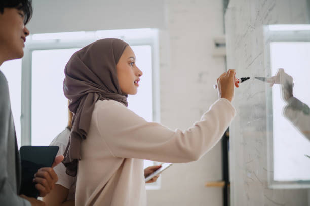 istock Malay Business Woman making a business presentation at a creative office 2149774796