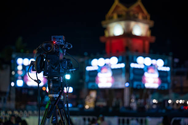 istock Video production team covers live event on stage. Professional crew utilizes multimedia for movie-like streaming. Expertise in cinematography and live broadcasting, Video equipment 2149774988