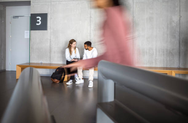 istock Diverse Students Engaging in Discussion at University Hallway Bench 2149775441