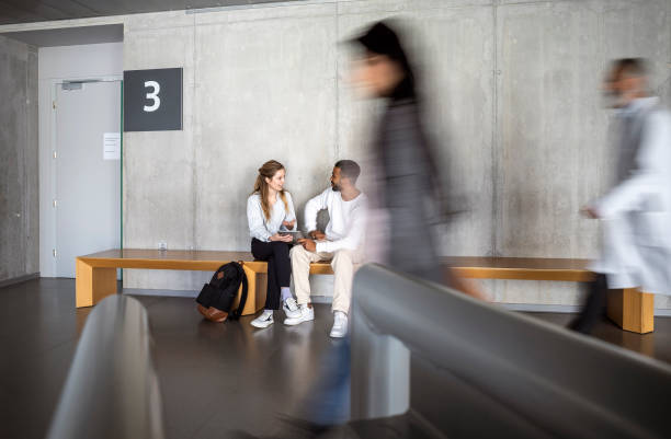 istock University Students Seated in Hallway Conversation 2149775442