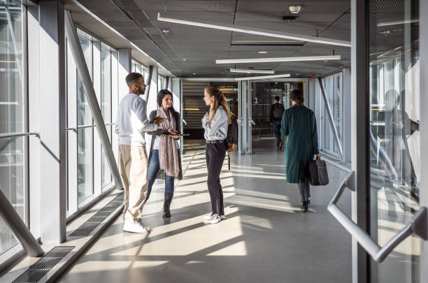 istock Diverse College Students Walking in Campus Hallway 2149775455