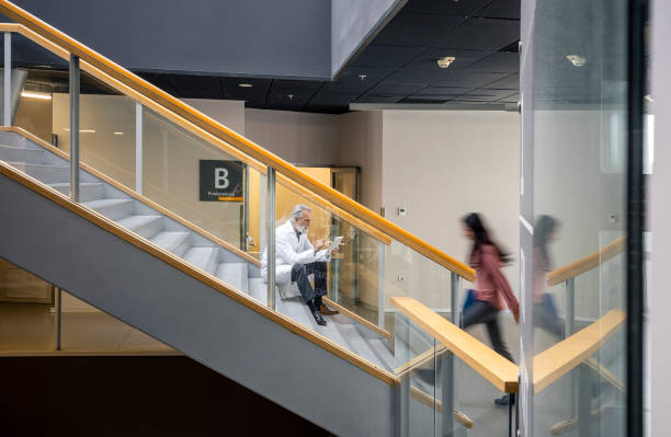 istock Diverse College Students Passing By Professor on Staircase 2149775473