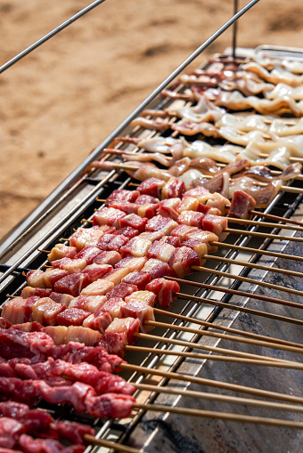 Camp on the beach and prepare seafood and meat barbecue