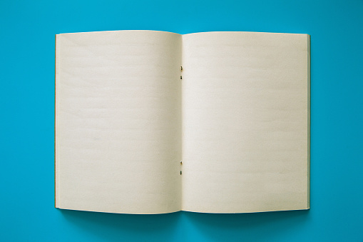 Blank  notebook on blue background. Copy space.