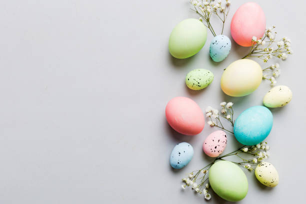 istock Happy Easter composition. Easter eggs on colored table with gypsophila. Natural dyed colorful eggs background top view with copy space 2149776075