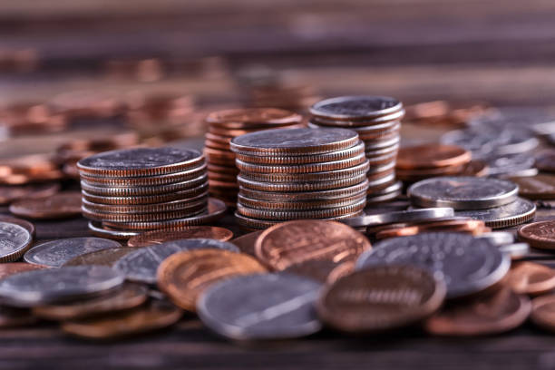 istock American coins and US dollars on a wooden table 2149777130