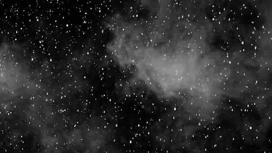 Abstract background of stars in the night sky with a few clouds