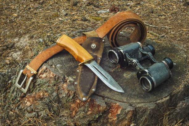istock Hunter knife in leather sheath, belt,  and old military binoculars 2149780464
