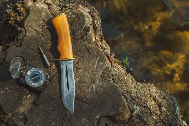 istock Hunting knife, old compass and cartridge 5.45 2149780504