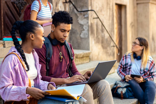 istock Diverse group of students sitting on stairs takling and learning together. 2149782463