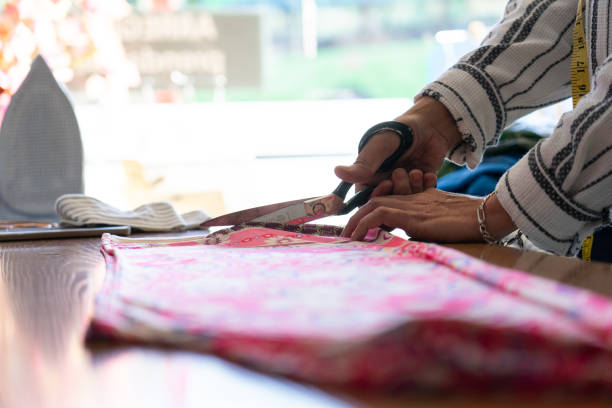 istock Fabric scissors cutting a fabric in a sewing shop 2149782590
