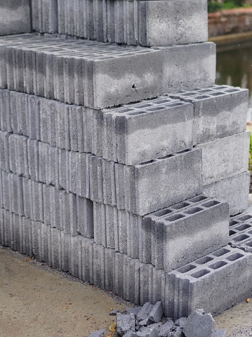 a photography of a pile of cinder blocks sitting on the ground.