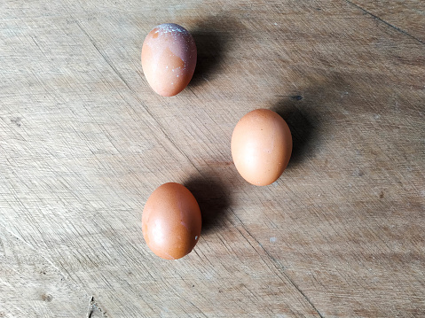 Eggs of a laying hen breed on a wooden board