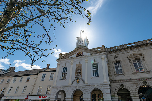 South Molton, UK. 18 April 2024. Shops by the South Molton Town Hall  in Devon on a sunny day.