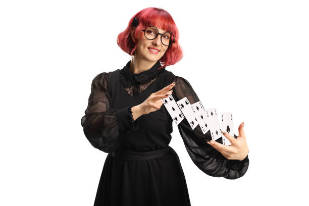 Female magician performing a trick with cards isolated on white background