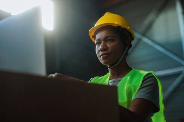 istock Female customs warehouse worker working on a laptop and thinking 2149784536
