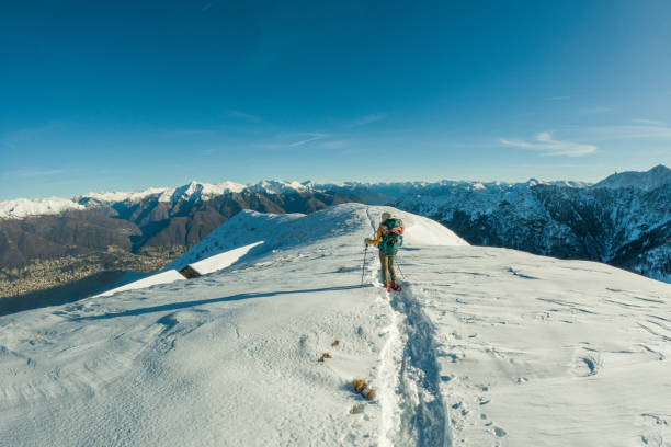 istock Woman going up a hill in winter 2149786052