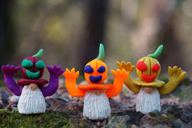 Figures of dwarfs decorated with pumpkin. Halloween decorations.