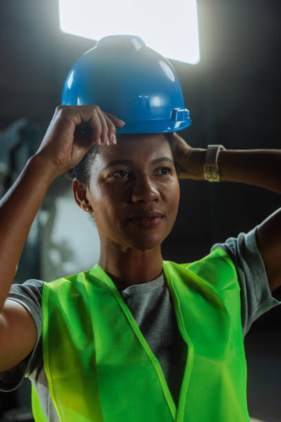 istock Customs warehouse female worker putting on her blue hardhat 2149786867