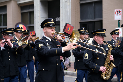 Norfolk, Virginia, USA:  April 20th 2024:  During the 75th annual NATO parade the United States military band march down the streets of Norfolk, Virginia playing their instruments.