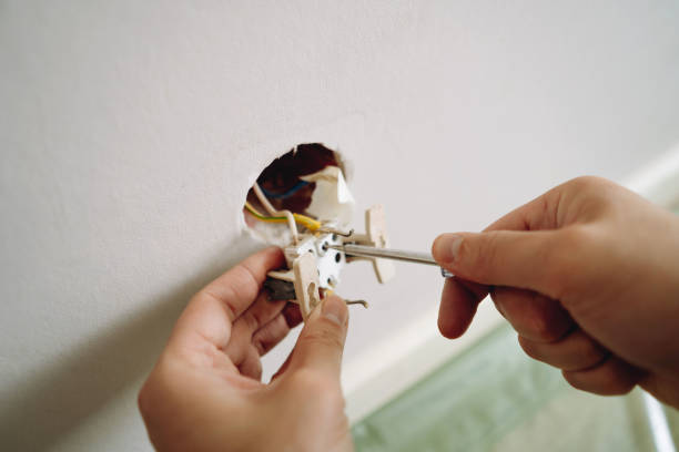 istock closeup view of man's hands installing socket with screwdriver. Renovation, repair concept 2149786988