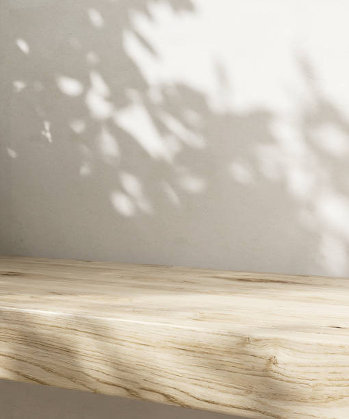 istock Minimal empty wooden countertop counter in sunlight, leaf foliage shadow on white wall 2149787023