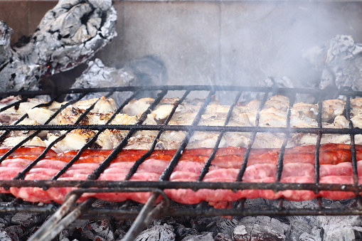 Eye-catching close-up of meat on a grill for dinner with friends