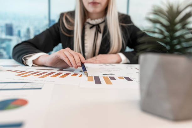 istock Business woman working  alone at the office with statistics charts and graph 2149787370