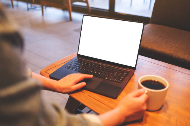 istock Mockup image of a woman using and working on laptop computer with blank white desktop screen while drinking coffee 2149788570