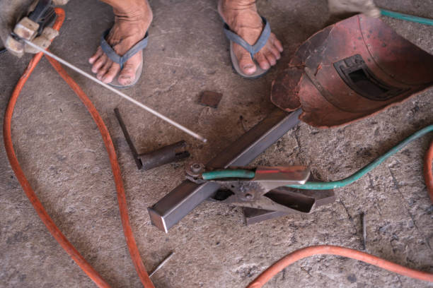istock Human hands hold welding equipment at a job site. 2149788991