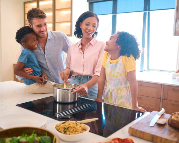 istock Multi-Racial Family Preparing Meal In Kitchen At Home Together 2149789352