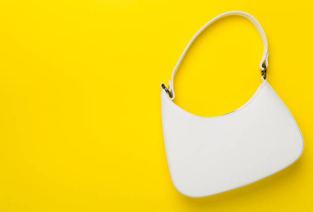 Woman hands holding fashionable and elegant pearl beaded white purse