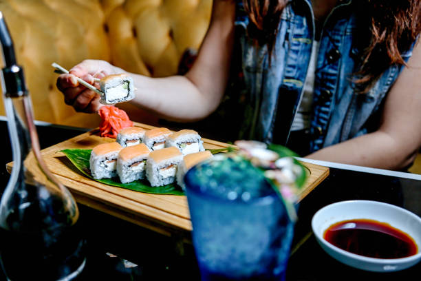 istock Woman Sitting at Table With Sushi Plate 2149789915