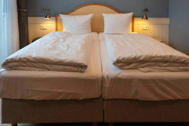 istock Large double bed bedside tables and lamps in the hotel room. 2149791119