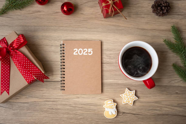 istock 2025 notebook, black coffee cup, Christmas cookies and pen on wood table, Top view and copy space. Xmas, Happy New Year, Goals, Resolution, To do list, Strategy and Plan concept 2149791454